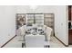 Elegant dining room with a glass table, seating for eight, and display shelving with decorations at 2404 Knoll Dr, Spring Hill, FL 34608