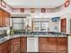 Kitchen with granite countertops, wood cabinets, stainless steel appliances, and a breakfast bar at 2404 Knoll Dr, Spring Hill, FL 34608