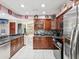 Updated kitchen featuring granite countertops, stainless steel appliances, and wooden cabinets at 2404 Knoll Dr, Spring Hill, FL 34608