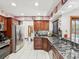 Kitchen featuring stainless steel appliances, granite countertops, and wood cabinets at 2404 Knoll Dr, Spring Hill, FL 34608