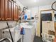 Practical laundry room with storage cabinets, a utility sink, and a washer-dryer set for convenience at 2404 Knoll Dr, Spring Hill, FL 34608