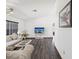 Serene living room featuring wood laminate floors, neutral walls, and a television for relaxation and entertainment at 2404 Knoll Dr, Spring Hill, FL 34608