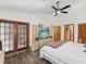 Primary bedroom featuring an en suite bathroom, vaulted ceilings, and patio access at 2404 Knoll Dr, Spring Hill, FL 34608