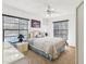 Comfortable main bedroom features a plush bed, ceiling fan, and backyard view at 2404 Knoll Dr, Spring Hill, FL 34608