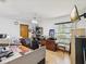 Bright office space featuring wood floors, a ceiling fan, window and wood door with modern appliances at 2404 Knoll Dr, Spring Hill, FL 34608