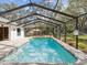 Sparkling screened-in pool with stone surround, perfect for outdoor entertaining and relaxation at 2404 Knoll Dr, Spring Hill, FL 34608