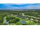 Stunning aerial view of the community surrounded by lush greenery and a pristine golf course at 2987 Wentworth Way, Tarpon Springs, FL 34688