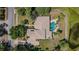 Overhead view of landscaped home with paved driveway, pool and spa, near a lush pond at 2987 Wentworth Way, Tarpon Springs, FL 34688