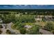 An aerial view of a luxury home with a pond, mature trees, and view of a golf course in the distance at 2987 Wentworth Way, Tarpon Springs, FL 34688