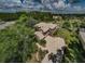 Expansive aerial view of home with pool, lush landscaping, and private driveway at 2987 Wentworth Way, Tarpon Springs, FL 34688