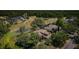 An aerial view of a luxury home with a pond in the backyard, surrounded by mature trees and a golf course at 2987 Wentworth Way, Tarpon Springs, FL 34688