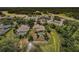 Aerial view of home with pool and lush landscaping near the golf course and clubhouse at 2987 Wentworth Way, Tarpon Springs, FL 34688