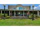 Lush backyard with an expansive covered patio, perfect for outdoor entertaining at 2987 Wentworth Way, Tarpon Springs, FL 34688