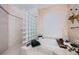 Elegant bathroom featuring a soaking tub, glass block shower, and plantation shutters at 2987 Wentworth Way, Tarpon Springs, FL 34688