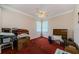 Bedroom with ceiling fan, multiple windows, and storage boxes, providing an organized space at 2987 Wentworth Way, Tarpon Springs, FL 34688