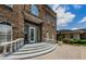 A detailed view of the Wentworth Golf Club's elegant entrance with a brick facade and white trim at 2987 Wentworth Way, Tarpon Springs, FL 34688