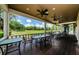 Expansive covered patio with golf course views, ceiling fans, and ample space for gatherings at 2987 Wentworth Way, Tarpon Springs, FL 34688