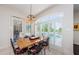 Dining room with plantation shutters, a wooden table, and chairs overlooking a pool at 2987 Wentworth Way, Tarpon Springs, FL 34688