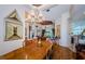 Spacious dining area with hardwood floors, chandelier, and an open layout at 2987 Wentworth Way, Tarpon Springs, FL 34688