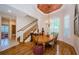 Formal dining room with hardwood floors, chandelier, and access to the stairway at 2987 Wentworth Way, Tarpon Springs, FL 34688