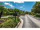 A view of the Wentworth entrance with a sign for residents and guests, plus lush landscaping at 2987 Wentworth Way, Tarpon Springs, FL 34688