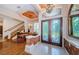 Elegant entryway boasts stained glass double doors, a chandelier, and access to the dining room and second floor at 2987 Wentworth Way, Tarpon Springs, FL 34688