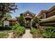 Inviting two-story home featuring a lush landscaped pathway leading to the front entrance at 2987 Wentworth Way, Tarpon Springs, FL 34688