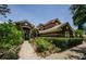 Elegant two-story home with lush landscaping and a well-maintained pathway leading to the entrance at 2987 Wentworth Way, Tarpon Springs, FL 34688