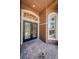 Close-up of decorative front doors, white trim, and brick pathway at 2987 Wentworth Way, Tarpon Springs, FL 34688