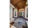 Elegant entryway with decorative glass front doors and a beautiful tile floor at 2987 Wentworth Way, Tarpon Springs, FL 34688