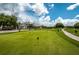 Beautiful golf course view featuring manicured greens and a picturesque clubhouse at 2987 Wentworth Way, Tarpon Springs, FL 34688