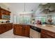 Kitchen with stainless steel appliances, wood cabinets, tile floors, and granite countertops at 2987 Wentworth Way, Tarpon Springs, FL 34688