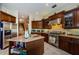 Kitchen with stainless steel appliances, custom cabinetry, granite counters, and an island with open shelving at 2987 Wentworth Way, Tarpon Springs, FL 34688
