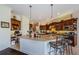 Kitchen with a large island and breakfast bar, stainless steel appliances, and custom cabinets at 2987 Wentworth Way, Tarpon Springs, FL 34688