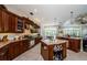 Gourmet kitchen with custom wood cabinetry, granite countertops, and stainless steel appliances at 2987 Wentworth Way, Tarpon Springs, FL 34688