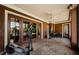 Covered lanai with exercise equipment and views of the pool, creating a relaxing outdoor living space at 2987 Wentworth Way, Tarpon Springs, FL 34688
