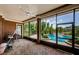 Screened lanai with a ceiling fan, outdoor seating, and scenic views of the pool area at 2987 Wentworth Way, Tarpon Springs, FL 34688
