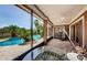 Covered lanai offering views of the pool, tropical landscaping, and access to outdoor amenities at 2987 Wentworth Way, Tarpon Springs, FL 34688