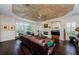 Spacious living room with a fireplace, large windows with plantation shutters, and wood floors at 2987 Wentworth Way, Tarpon Springs, FL 34688
