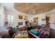 Living area featuring a fireplace, hardwood floors, and leather furniture at 2987 Wentworth Way, Tarpon Springs, FL 34688