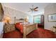 Main bedroom with a king bed, ceiling fan and shuttered window at 2987 Wentworth Way, Tarpon Springs, FL 34688