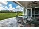 Inviting covered patio with comfortable seating, perfect for enjoying golf course views at 2987 Wentworth Way, Tarpon Springs, FL 34688