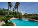 Picturesque backyard pool with tropical landscaping and spa water feature at 2987 Wentworth Way, Tarpon Springs, FL 34688