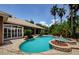 Beautiful pool with spa, and a tiled patio surrounded by lush tropical landscaping at 2987 Wentworth Way, Tarpon Springs, FL 34688