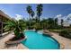 Stunning pool with spa, lush tropical landscaping, and waterfall feature at 2987 Wentworth Way, Tarpon Springs, FL 34688