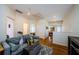 Cozy sitting room features a comfortable blue sofa, ottoman, hardwood floors, and access to other rooms at 2987 Wentworth Way, Tarpon Springs, FL 34688
