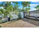 View of the side yard of the house with a screened porch and cactus at 3118 Lloyd Dr, Holiday, FL 34691