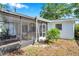 View of the side yard and screened in porch at 3118 Lloyd Dr, Holiday, FL 34691