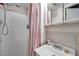 Standard bathroom featuring a walk-in shower with a patterned curtain and a sink with a medicine cabinet at 3118 Lloyd Dr, Holiday, FL 34691