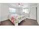 Bright bedroom offers ample storage with built-in wardrobes and a charming ceiling fan at 3118 Lloyd Dr, Holiday, FL 34691